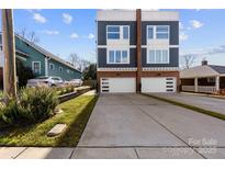 Modern two-story home featuring a concrete driveway, two-car garage, and contemporary design at 327 Coxe Ave, Charlotte, NC 28208