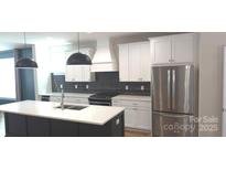 Modern kitchen features stainless steel appliances, granite countertops, and a large island at 327 Coxe Ave, Charlotte, NC 28208