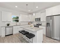 Modern kitchen with white cabinets, granite countertops, and stainless steel appliances at 4039 Northerly Island Ct, Gastonia, NC 28056