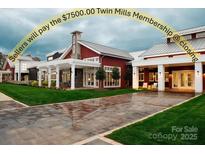 Red barn style home exterior with white columns and a paved driveway at 423 Granite Lake Ct, Denver, NC 28037