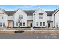 New construction townhome featuring farmhouse-style design, light-colored wood beams, and a landscaped front yard at 444 Berryman Rd, Rock Hill, SC 29732