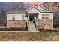 House exterior featuring stone and siding accents, a front porch, and landscaping at 5120 Kings Pinnacle Dr, Kings Mountain, NC 28086