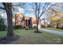 Brick two-story house with a large yard and driveway at 6239 Oxwynn Ln, Charlotte, NC 28270