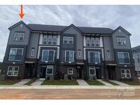 Modern townhome exteriors with large windows and brick accents for stylish curb appeal at 1324 Walter Taylor Way # Eqx0101, Charlotte, NC 28206