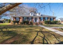 Brick ranch home with landscaped yard and walkway at 101 Wynnchester Rd, Gastonia, NC 28056