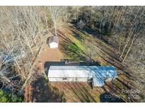 Aerial view of single-wide mobile home, detached shed, and large yard at 3586 Bridle Path Dr, Vale, NC 28168