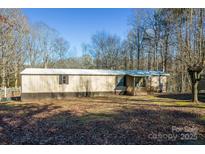 Single-wide mobile home on wooded lot with deck at 3586 Bridle Path Dr, Vale, NC 28168