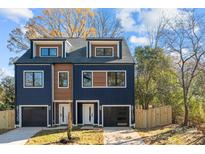 Modern two-unit building, navy and brown, with attached garages and fenced yards at 137 S Smallwood Pl, Charlotte, NC 28208