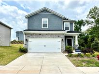 Charming two-story home featuring stone accents, a two-car garage, and a well-maintained front yard at 102 Alden Ct, Shelby, NC 28152