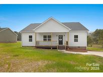 Charming single-story home with a covered front porch and fresh white siding under a blue sky at 524 Waco Rd, Kings Mountain, NC 28086