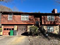 Two-story house with wood siding, stone accents, and a two-car garage at 6219 Long Pine Dr # 32, Charlotte, NC 28227