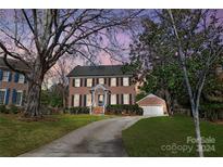 Brick home with landscaped yard, driveway, and attached garage at 1103 Hulston Ct, Charlotte, NC 28211