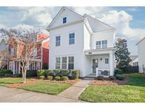 Charming two-story white home with manicured front yard landscaping and welcoming entryway at 1209 Cedar Park Dr, Pineville, NC 28134