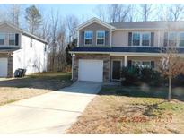 Two-story townhome with stone accents and a driveway at 274 Village Creek Way, Salisbury, NC 28147