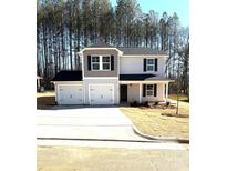 Charming two-story home with a three-car garage and a well-manicured front yard at 446 Deaton St, Statesville, NC 28677