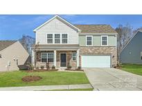 Two-story house with stone and siding accents, a two-car garage, and a well-manicured lawn at 1070 Old Trade St, Edgemoor, SC 29712