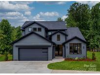 Gray two-story house with modern design and attached garage at 8039 Mcconnell Rd, Denver, NC 28037