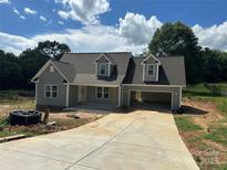 Charming new construction home featuring a gray exterior, dormer windows, and an attached two car carport at 184 Maplewood Ln, Taylorsville, NC 28681