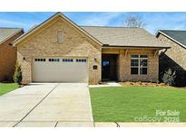 Charming brick home with a two-car garage, well-manicured lawn, and inviting front entrance at 409 Newstyle Way # 3, Cramerton, NC 28056