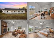 White house with a front porch, large windows, and a grassy yard at 4759 Mel Nunnery Rd, Fort Lawn, SC 29714