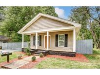 Charming craftsman home with gray siding, front porch, and landscaped yard at 612 Calvary St, Shelby, NC 28150