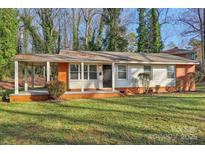 Brick ranch home with covered porch and landscaped yard at 2016 Norwich Pl, Charlotte, NC 28208