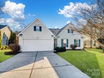 House exterior featuring a two-car garage and well-maintained lawn at 2532 Governors Pointe Ne Ct, Concord, NC 28025