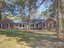 Charming brick home featuring a well-maintained lawn and inviting curb appeal at 5529 Five Knolls Dr, Charlotte, NC 28226