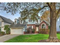 Two-story house with blue siding, brick accents, and a landscaped lawn at 6415 Outer Bridge Ln, Charlotte, NC 28270