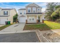 Two-story house with attached garage and small front yard at 13406 Tartarian Ct, Charlotte, NC 28215