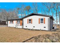 Newly renovated ranch home with modern exterior and landscaping at 2108 Sherwood Forest Ln, Monroe, NC 28110