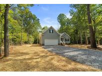 Gray house with a white garage door and landscaping at 2754 Crowders Creek Rd, Gastonia, NC 28052