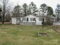 A quaint single-story home featuring a covered porch and mature trees at 3958 Benny Shrum Ln, Maiden, NC 28650