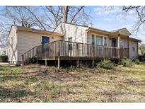 Beige ranch style house with large deck, backyard and blue front door at 503 N Boyce St, Gastonia, NC 28052