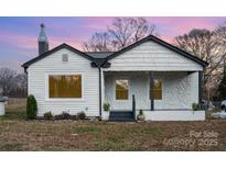 Charming single-story home with white siding, black trim and stone-accented porch at 5204 Dellinger Cir, Cherryville, NC 28021