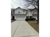 Two-story townhome with attached garage and landscaped front yard at 6132 Pale Moss Ln, Charlotte, NC 28269