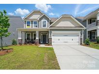 Charming two-story home with a two-car garage, a well-manicured lawn, and a welcoming front porch at 8230 Verona Rd # 80, Charlotte, NC 28213