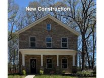 Charming new construction two-story home with a covered porch and brick facade at 4739 Whispering Oaks Dr, Charlotte, NC 28213