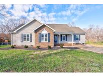 Brick and siding ranch home with mature landscaping and a spacious yard at 108 Landing Ct # 36, Bessemer City, NC 28016