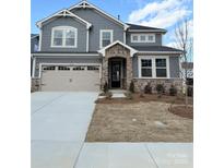 Beautiful two-story home with stone accents, a two-car garage, and a well-manicured front lawn at 1432 Mccollum N St, Monroe, NC 28112