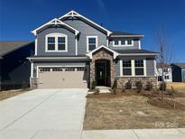 Charming two-story home with stone accents, a two-car garage, and manicured front yard landscaping at 1432 Mccollum N St, Monroe, NC 28112