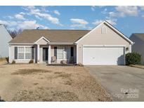 Beige house with a two-car garage and landscaping at 1630 Hardy Dr, Rock Hill, SC 29732