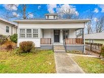 Charming white bungalow with front porch and landscaped yard at 526 S Green St, Statesville, NC 28677