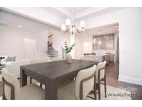 This dining room features an open-concept design with modern lighting and views to the kitchen and staircase at 1364 Cedardale Ln, Denver, NC 28037