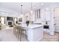 Bright kitchen features an island with marble countertop, modern appliances, and pendant lighting at 1374 Cedardale Ln # 33, Denver, NC 28037