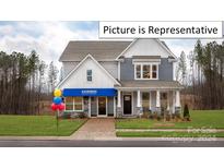 Two-story home with gray siding, white trim, and a welcoming front porch at 2019 Canvasback Way, Indian Trail, NC 28079