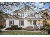 Two-story house with white siding, brown shutters, and a brick staircase at 5022 Saybrook Dr, Harrisburg, NC 28075