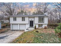 Charming split-level home with white siding, a two-car garage, and a well-maintained front yard at 6726 Wannamaker Ln, Charlotte, NC 28226