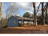 Ranch home with wraparound porch and mature trees at 733 Azalea Dr, Chester, SC 29706