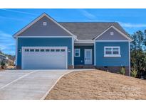 Charming home with a two-car garage, beautiful blue siding, and a well-manicured lawn at 9405 Tradewinds Ct, Lancaster, SC 29720